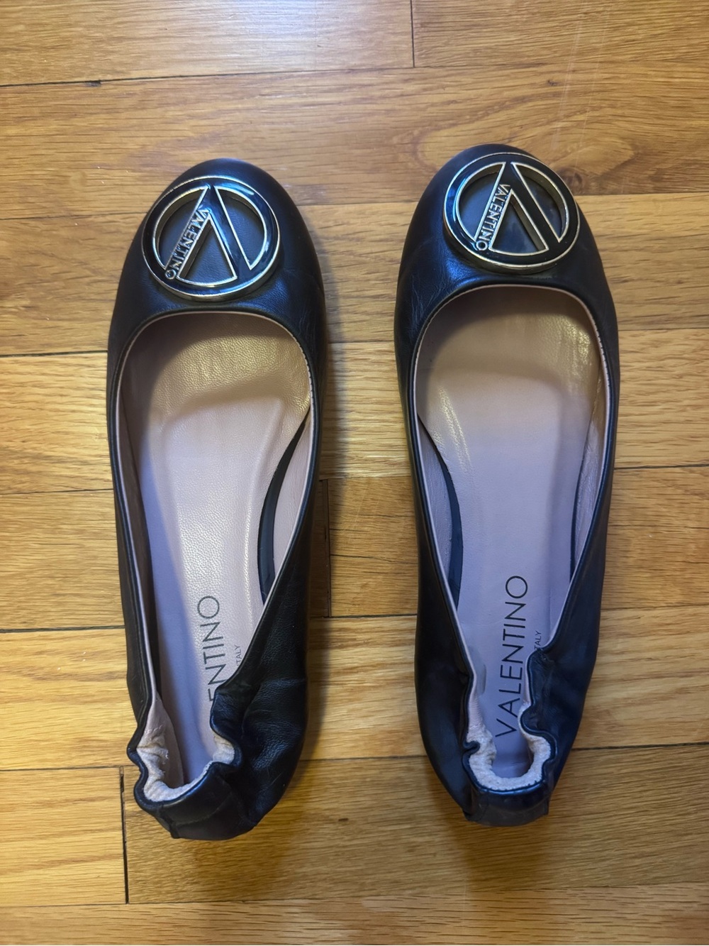 Valentino By Mario Black Leather Ballet Flats with Gold Logo Medallion